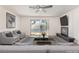 Well-lit living room with backyard pool view, fireplace, and light-colored walls at 4301 Fortune Ave, Las Vegas, NV 89107