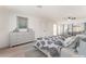 Spacious main bedroom with a large dresser, mirrored closet doors, and ceiling fan at 4301 Fortune Ave, Las Vegas, NV 89107