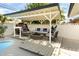 Outdoor lounge area featuring comfortable seating, a fire pit, and shaded pergola at 4301 Fortune Ave, Las Vegas, NV 89107