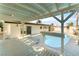 Backyard featuring a pool, a deck, a covered patio, and a white privacy wall at 4301 Fortune Ave, Las Vegas, NV 89107
