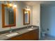 Modern bathroom with double sinks, granite countertop, wood cabinets, and framed mirrors at 4575 Dean Martin Dr # 3206, Las Vegas, NV 89103