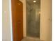 Bathroom with glass enclosed shower and wood storage at 4575 Dean Martin Dr # 3206, Las Vegas, NV 89103