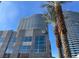 Modern high-rise building featuring a sleek facade, palm trees, and a blue sky backdrop at 4575 Dean Martin Dr # 3206, Las Vegas, NV 89103