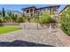 Spacious backyard featuring artificial turf, statues, patio, basketball hoop and mature landscaping at 459 Astillero St, Las Vegas, NV 89138