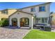 Backyard featuring a covered patio with an outdoor kitchen, a seating area, and artificial turf at 459 Astillero St, Las Vegas, NV 89138