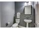 This stylish powder room features a pedestal sink, decorative mirror, and modern fixtures at 459 Astillero St, Las Vegas, NV 89138