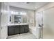Modern bathroom with a double sink vanity, bathtub, and a separate shower with glass door at 459 Astillero St, Las Vegas, NV 89138