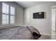 Bright bedroom with shutters, a mounted television, and ample natural light at 459 Astillero St, Las Vegas, NV 89138