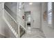 Bright entryway with staircase features herringbone flooring and a clear view to the adjacent bedroom at 459 Astillero St, Las Vegas, NV 89138