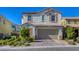 Charming two-story home with a two-car garage and a beautifully landscaped front yard at 459 Astillero St, Las Vegas, NV 89138