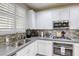 Modern kitchen features stainless steel appliances, tile backsplash, and ample counter space at 459 Astillero St, Las Vegas, NV 89138