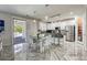 Modern open-concept kitchen with white cabinetry, stainless steel appliances, and a center island with seating at 459 Astillero St, Las Vegas, NV 89138