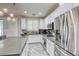 Well-lit kitchen boasts stainless steel appliances, a spacious island and tile flooring at 459 Astillero St, Las Vegas, NV 89138