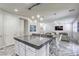 This open-concept kitchen includes an island with bar seating and leads to a comfortable seating area at 459 Astillero St, Las Vegas, NV 89138