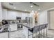 Open kitchen with an island including bar stool seating, stainless steel appliances, and convenient pantry access at 459 Astillero St, Las Vegas, NV 89138