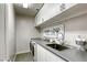 Modern laundry room with stainless steel sink, countertop, washing machine and dryer hookups at 459 Astillero St, Las Vegas, NV 89138