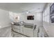 Bright living room features a sectional sofa, ceiling fan, and large TV, perfect for relaxing at 459 Astillero St, Las Vegas, NV 89138