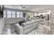 Bright, open-concept living room featuring stylish tile flooring, a modern sofa, and abundant natural light at 459 Astillero St, Las Vegas, NV 89138