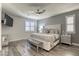 Stylish main bedroom featuring plank floors, a ceiling fan, tv, and a well-appointed bed at 459 Astillero St, Las Vegas, NV 89138