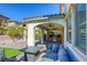 Covered outdoor kitchen featuring a built-in grill, countertops, and a seating area with comfortable furniture at 459 Astillero St, Las Vegas, NV 89138