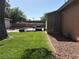 Exterior of home with green grass yard and covered parking area at 461 N Lamb Blvd # H, Las Vegas, NV 89110