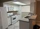 Well-lit kitchen features a skylight, white cabinetry, gray countertops, and stainless steel appliances at 461 N Lamb Blvd # H, Las Vegas, NV 89110