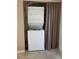 A closet with stackable washer dryer, behind a privacy curtain at 461 N Lamb Blvd # H, Las Vegas, NV 89110