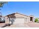 Charming single-story home with a two-car garage, desert landscaping, and a well-maintained front yard at 472 Tiger Lily Way, Henderson, NV 89015