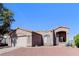 Inviting one-story home featuring desert landscaping, a two-car garage, and a warm, welcoming facade at 472 Tiger Lily Way, Henderson, NV 89015