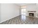 Cozy living area with fireplace, sliding glass doors to the backyard, and abundant natural light at 472 Tiger Lily Way, Henderson, NV 89015