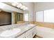 The main bathroom features granite countertops, dual sinks, a soaking tub, and a separate shower with glass doors at 472 Tiger Lily Way, Henderson, NV 89015