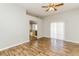 Large main bedroom boasting an ceiling fan, wood-look floors, and direct access to the en suite bathroom at 472 Tiger Lily Way, Henderson, NV 89015