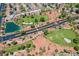 Stunning aerial view showcasing a golf course, pond, and a neighborhood at 5133 Burr Oak Dr, Las Vegas, NV 89130
