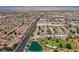 Great aerial view of a pond near a golf course and suburban community at 5133 Burr Oak Dr, Las Vegas, NV 89130