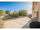 A large backyard patio extends to rock landscaping near the grass at 5133 Burr Oak Dr, Las Vegas, NV 89130