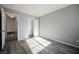 A bright bedroom featuring wood-look flooring, closet and open door at 5133 Burr Oak Dr, Las Vegas, NV 89130
