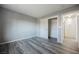 A bright bedroom featuring wood-look flooring, closet and open door at 5133 Burr Oak Dr, Las Vegas, NV 89130