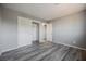 A bright bedroom featuring wood-look flooring, closet and open door at 5133 Burr Oak Dr, Las Vegas, NV 89130