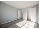A bright bedroom featuring wood-look flooring, closet and open door at 5133 Burr Oak Dr, Las Vegas, NV 89130