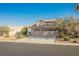 Two-story home featuring a two-car garage and desert landscaping at 5133 Burr Oak Dr, Las Vegas, NV 89130