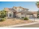 Two-story home featuring a two-car garage and desert landscaping at 5133 Burr Oak Dr, Las Vegas, NV 89130