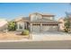 Two-story home featuring a two-car garage and desert landscaping at 5133 Burr Oak Dr, Las Vegas, NV 89130