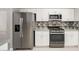 Updated kitchen with stainless steel appliances and white cabinets, perfect for cooking at 5133 Burr Oak Dr, Las Vegas, NV 89130