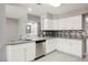 Open kitchen featuring stainless appliances, granite countertops, mosaic backsplash, and ample storage in a stylish, functional design at 5133 Burr Oak Dr, Las Vegas, NV 89130