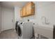 Laundry room with sink, cabinets and new washer and dryer at 5133 Burr Oak Dr, Las Vegas, NV 89130