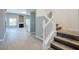 Open-concept living room with a cozy fireplace, wood-look floors, and large windows, offering ample natural light and a modern feel at 5133 Burr Oak Dr, Las Vegas, NV 89130