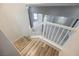 Staircase with wood-look flooring and white railings, leading to the lower level at 5133 Burr Oak Dr, Las Vegas, NV 89130