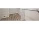 Close up of a walk-in closet with wood look floors and metal shelves and racks at 5133 Burr Oak Dr, Las Vegas, NV 89130
