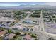 Aerial shot features a modern home with a pool and landscaping, surrounded by a developing suburban neighborhood at 5400 Mello Ave, Las Vegas, NV 89131