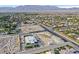 Aerial showcases a modern home with pool and landscaping in a developing area within an established suburban neighborhood at 5400 Mello Ave, Las Vegas, NV 89131